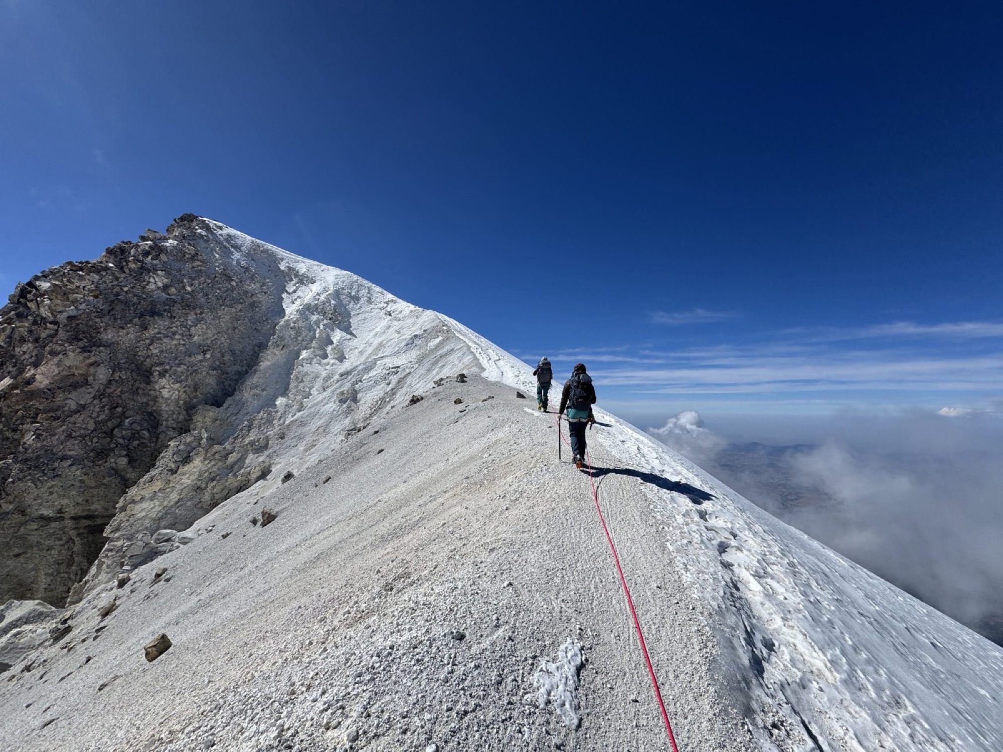 Two roped climbers on the snowy summit ridge of Pico de Orizaba