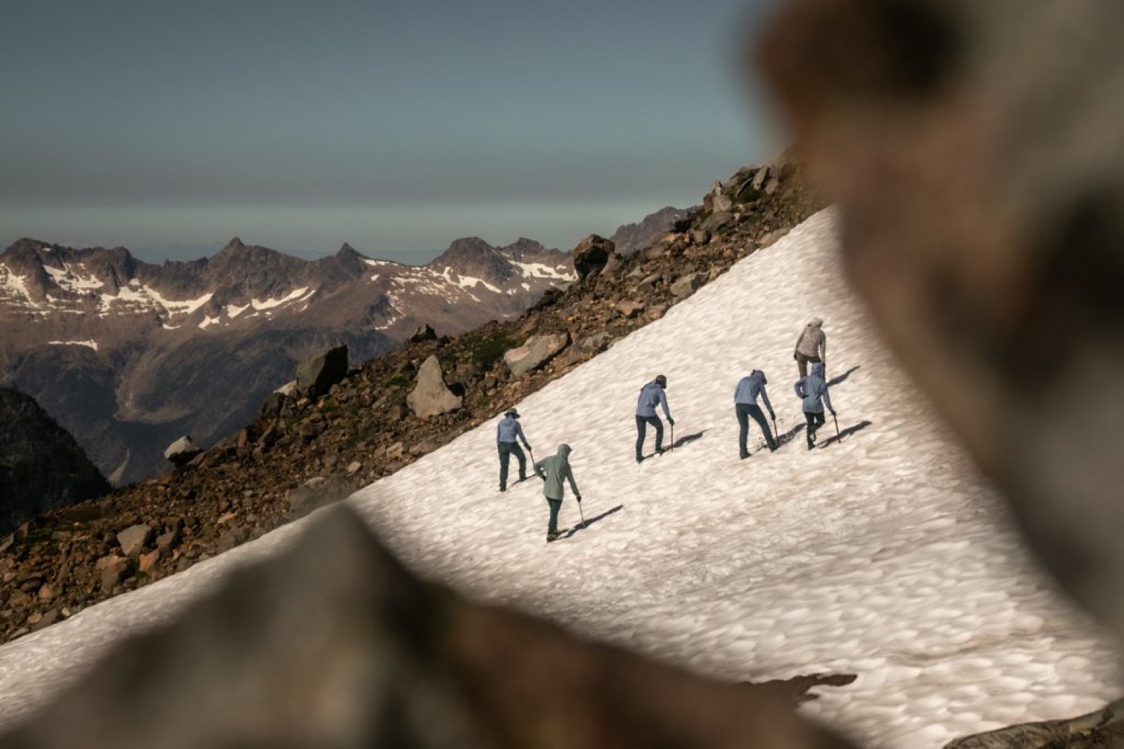 A rope team of young women crossing a steep snowfield on Mount Baker